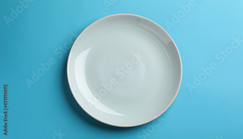 One clean plate on light blue background, top view. Space for text