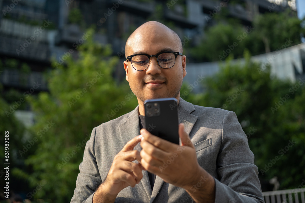 Senior manager business man in suit with cell phone at the buildings downtown. Confident man using smartphone looking towards their goals for success. Executive business man Senior manager business man in suit with cell phone at the buildings downtown. Confident man using smartphone looking towards their goals for success. Executive business man