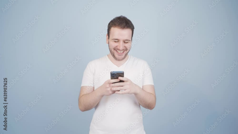 Happy man texting on the phone. Smiling. Happy man texting on the phone. Smiling.