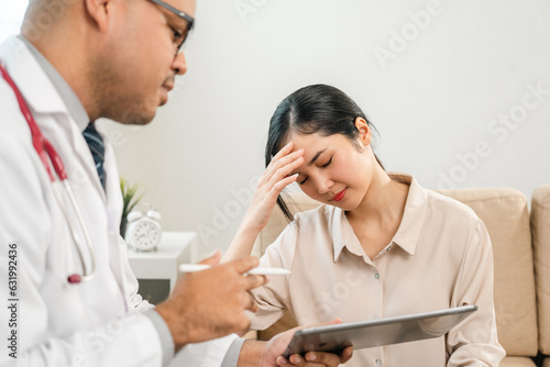 Asian Doctor and patient discussing consulting with digital tablet. Patient meet talking with Doctor giving pills bottle to woman at hospital. Medicine and health care treatment result in clinic