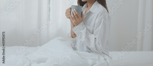 Happy freelance asian woman work on tablet on the hotel bed on travel trip.