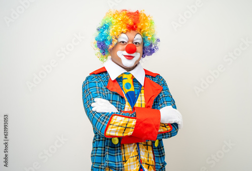 Mr Clown. Portrait of Funny face Clown man in colorful uniform standing arms crossed smiling to camera. Happy expression male bozo in various pose on isolated background. photo