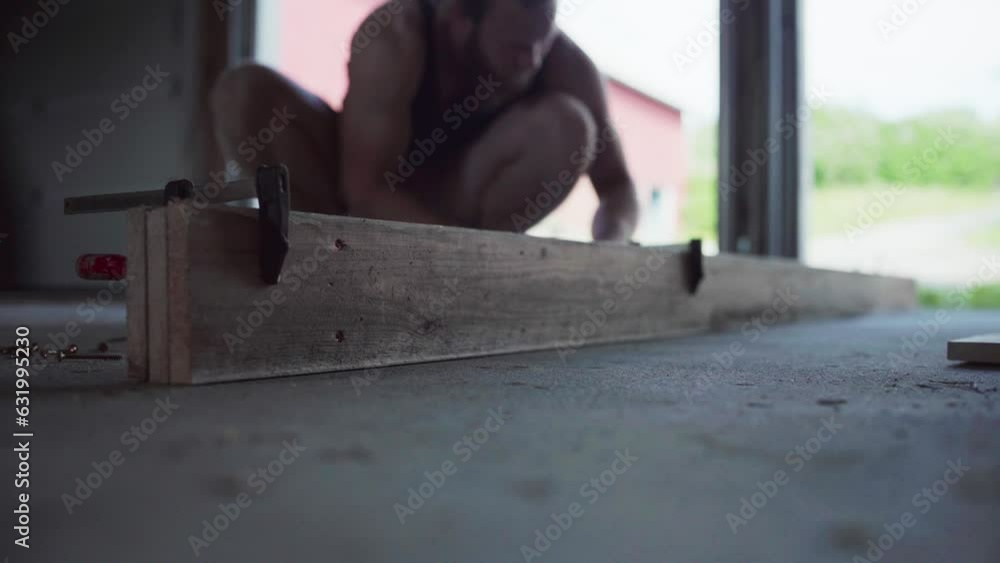 Carpenter Using Clamps On Wooden Plank In Workshop. Close Up Carpenter Using Clamps On Wooden Plank In Workshop. Close Up