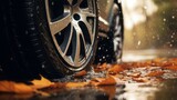 Close-up of a car tyre sliding on wet leaves