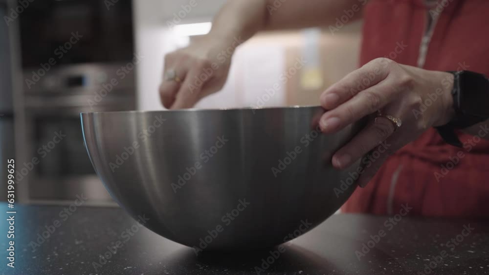 Woman Mixing Flour and Cake Ingredients in Stainless Steel Bowl. Woman Mixing Flour and Cake Ingredients in Stainless Steel Bowl.