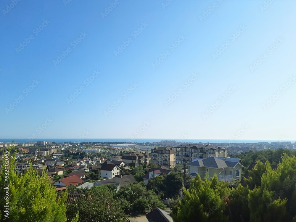 Panoramic top view of many houses on the blue sea horizon