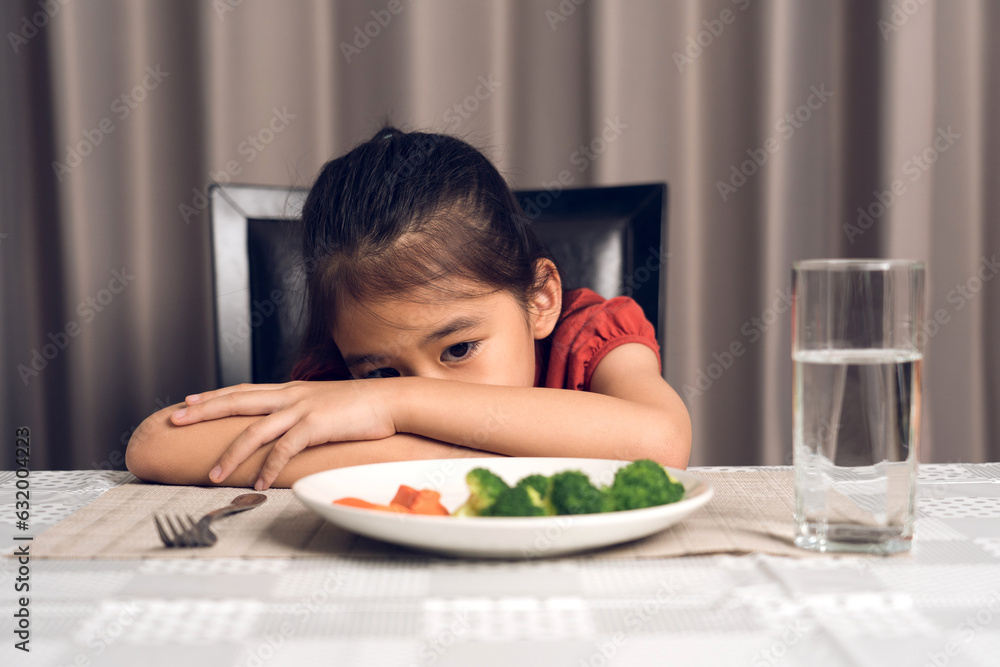Little cute kid girl refusing to eat healthy vegetables. Children do not like to eat vegetables. Little cute kid girl refusing to eat healthy vegetables. Children do not like to eat vegetables.