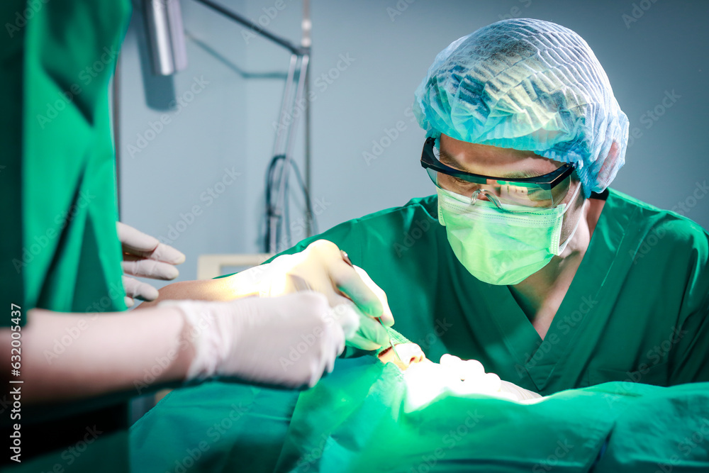 surgical team Performing facial surgery on a patient lying on the bed in the operating room. Emergency surgery. medical services in hospitals surgical team Performing facial surgery on a patient lying on the bed in the operating room. Emergency surgery. medical services in hospitals