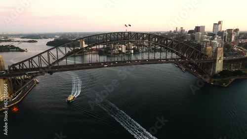 Drone aerial point of view of Sydney harbour bridge with traffic driving car and cityscape skyline with skyscrapers office building in NSW, Australia. Landmark famous place transportation concept.