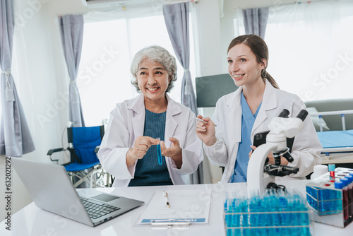 Scientists are doing research in a medical laboratory. Foreground researcher using a microscope