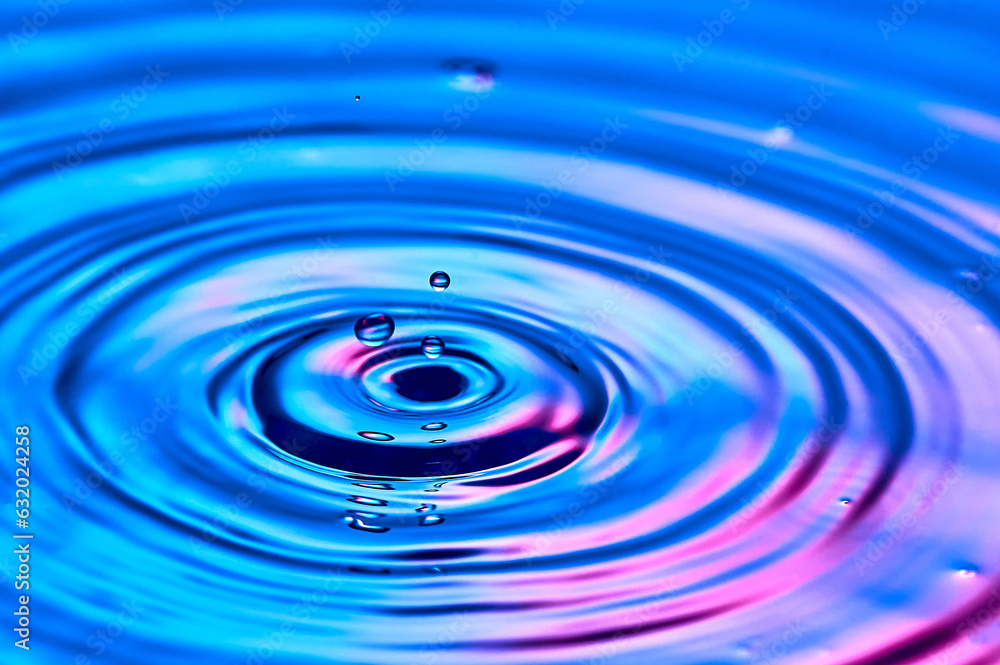 a drop of water falling into the water and creating waves a drop of water falling into the water and creating waves