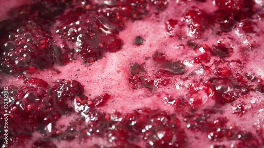 Cooking raspberry jam. Boling raspberry fruits for jam close up Cooking raspberry jam. Boling raspberry fruits for jam close up