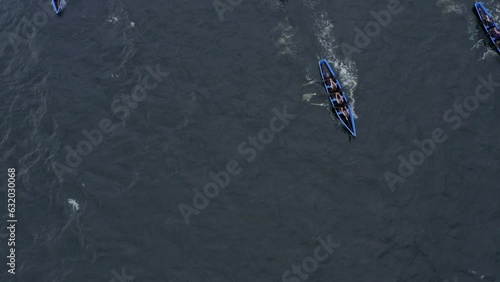 Top down aerial perspective of currach boats crossing open ocean water rowing photo