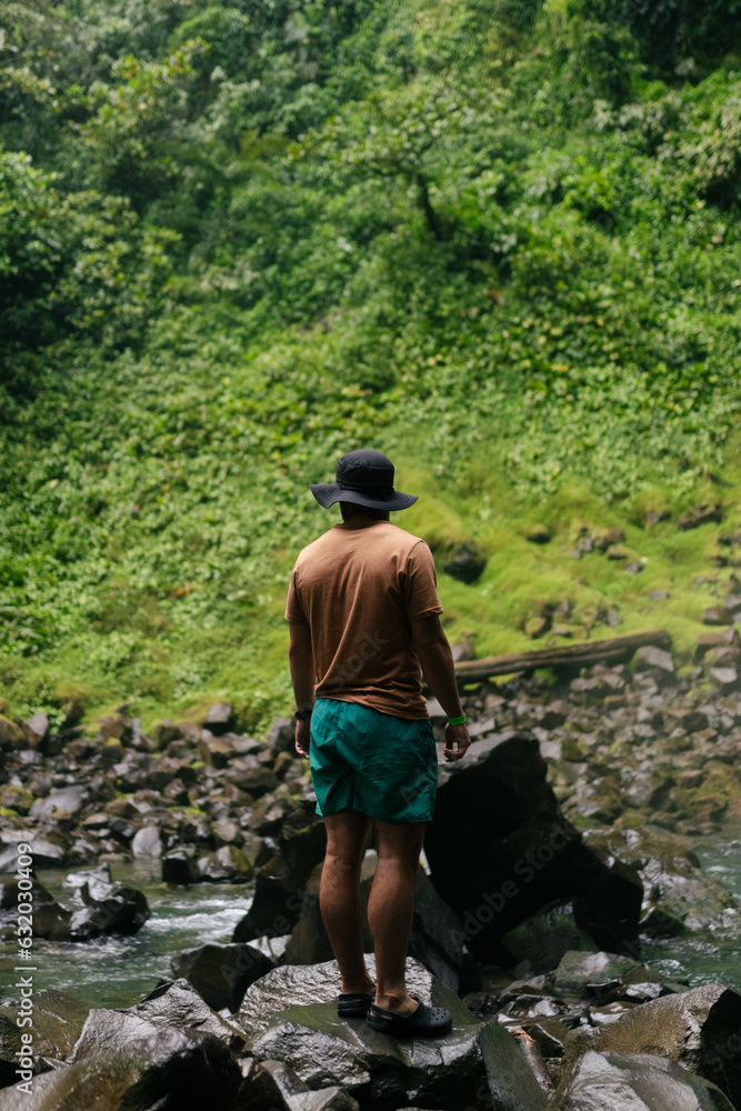 Young man standing on a rock Young man standing on a rock
