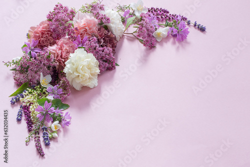 beautiful summer flowers on pink paper background