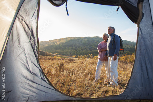 Camping tent vacation and adult couple man and woman enjoying freedom at forest