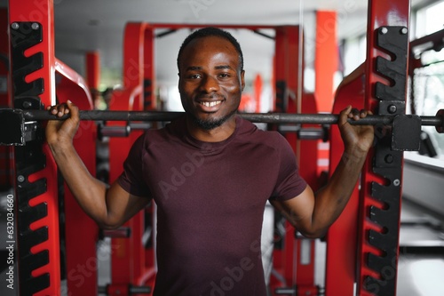 Handsome young African American man working out at the gym