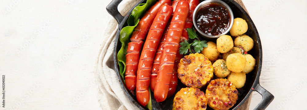 Grilled meat sausages in a pan with vegetables. Grilled meat sausages in a pan with vegetables.
