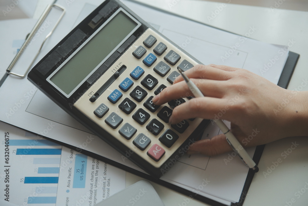 Unrecognizable businessman using calculator Unrecognizable businessman using calculator