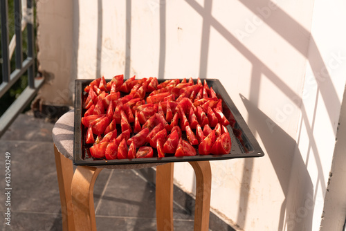Sun-dried tomatoes on a pan. Fresh tomatoes © Nino Lavrenkova