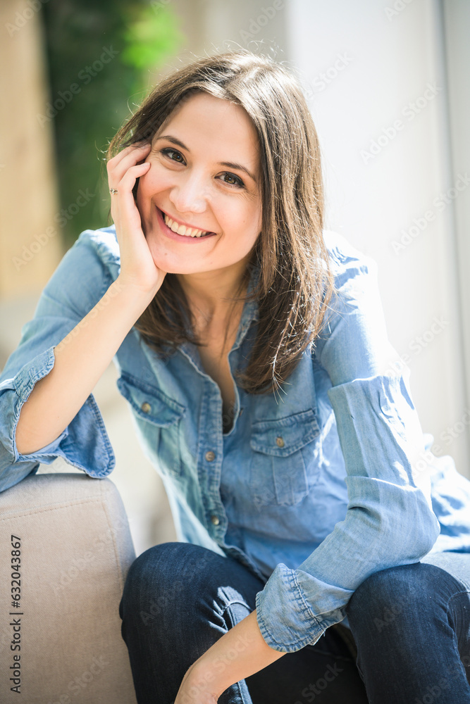 Portrait of happy woman wearing denim shirt at home Portrait of happy woman wearing denim shirt at home