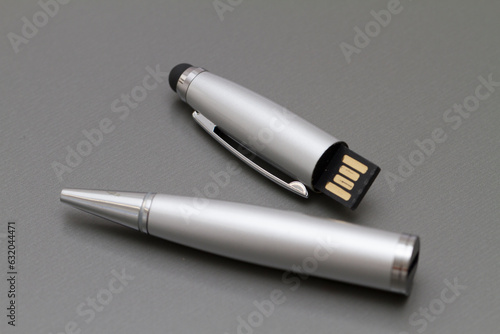 Macro shot of USB pen drive resting on a studio background.