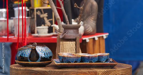 Photography Tea pot and bowls on display in a stall selling a variety of ceramics in the mar