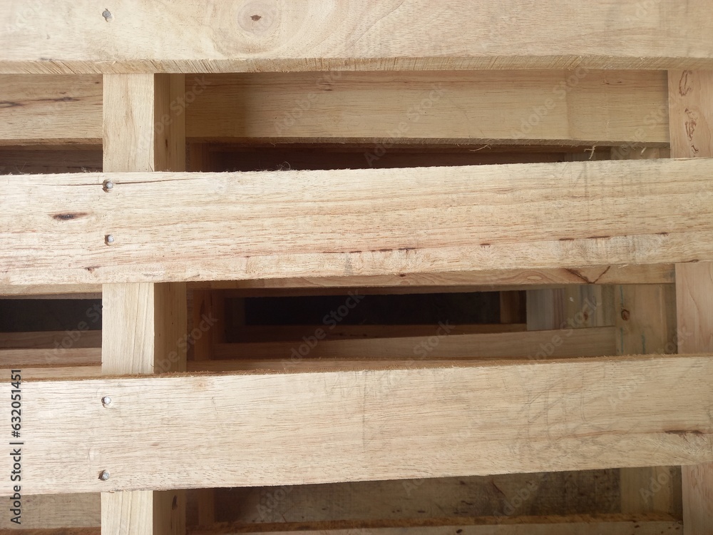 Pallets are stacked together, revealing layers of wood stacked on top of each other. Pallets are stacked together, revealing layers of wood stacked on top of each other.