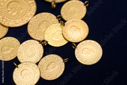 Принти на полотні The pile of full, half and quarter Turkish gold coins on a dark navy blue backgr