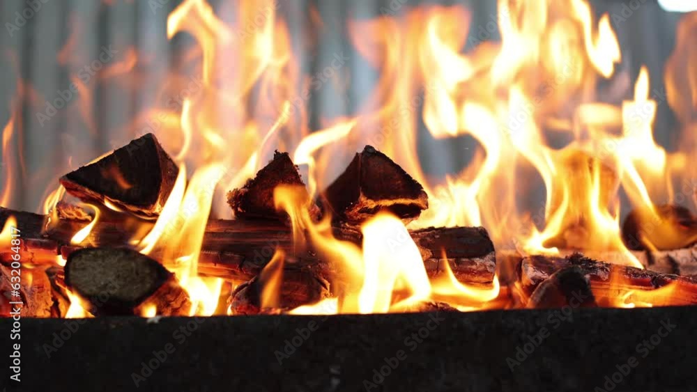 Bonfire in the yard. Preparation for a picnic, barbecue at the campfire, rest at the end of the week. Firewood is burning in the barbecue, it is very hot. Flame from dry firewood, fuel for cooking Bonfire in the yard. Preparation for a picnic, barbecue at the campfire, rest at the end of the week. Firewood is burning in the barbecue, it is very hot. Flame from dry firewood, fuel for cooking