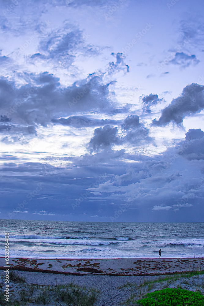 Fototapeta premium Sunrise on a stormy winter day with clouds at Sea Ranch beach in Indialantic Florida