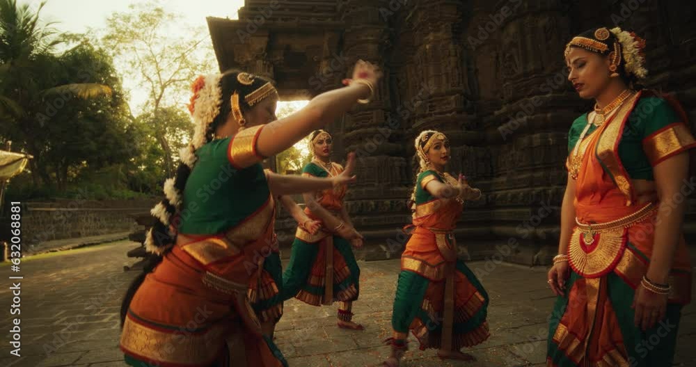 Slow Motion of Female Indian Lead Dancer Explaining to her Team Dancers the Moves of a Traditional Choreography. Girls in Colorful Clothes Rehearsing for a Performance in an Ancient Temple Slow Motion of Female Indian Lead Dancer Explaining to her Team Dancers the Moves of a Traditional Choreography. Girls in Colorful Clothes Rehearsing for a Performance in an Ancient Temple