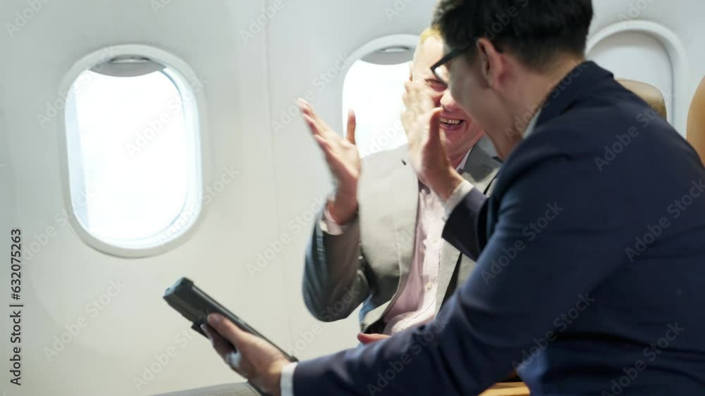 Young and senior businessman using laptop sitting near window on international first class plane passenger business partner Wealthy company executives traveling for work travel and business Young and senior businessman using laptop sitting near window on international first class plane passenger business partner Wealthy company executives traveling for work travel and business