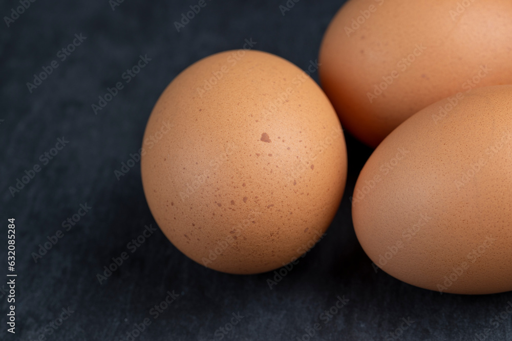 A clean whole orange chicken egg close-up on the table A clean whole orange chicken egg close-up on the table