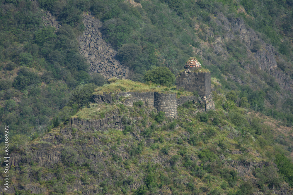 Ruins and walls of an old castle. Fortress on top of a mountain