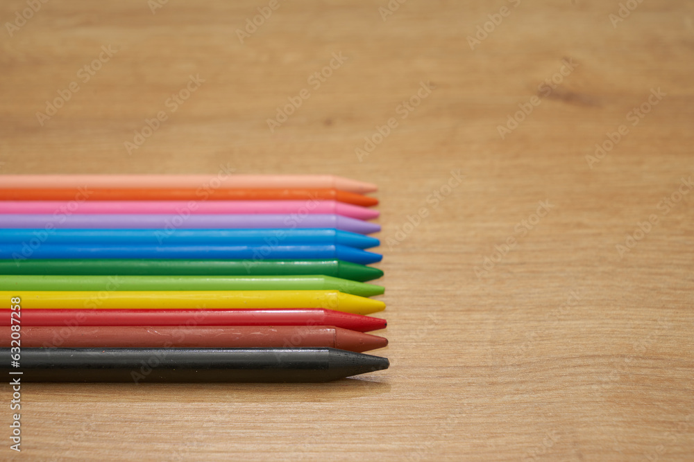 Colorful crayons on a wooden table. Childhood. Colorful crayons on a wooden table. Childhood.