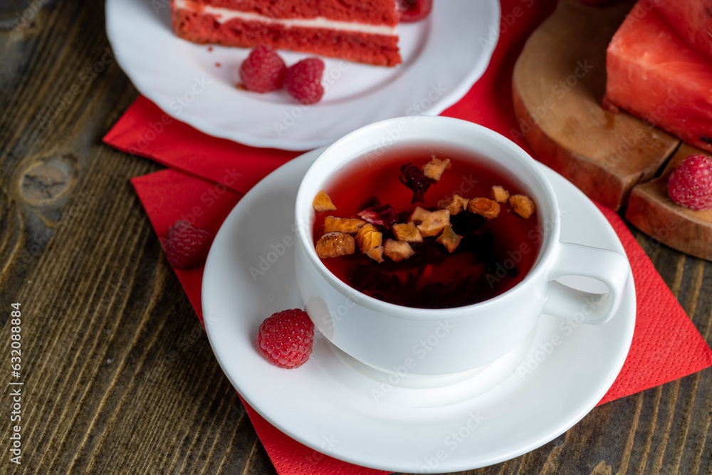 Red raspberry tea with pieces of fruit and berries Red raspberry tea with pieces of fruit and berries