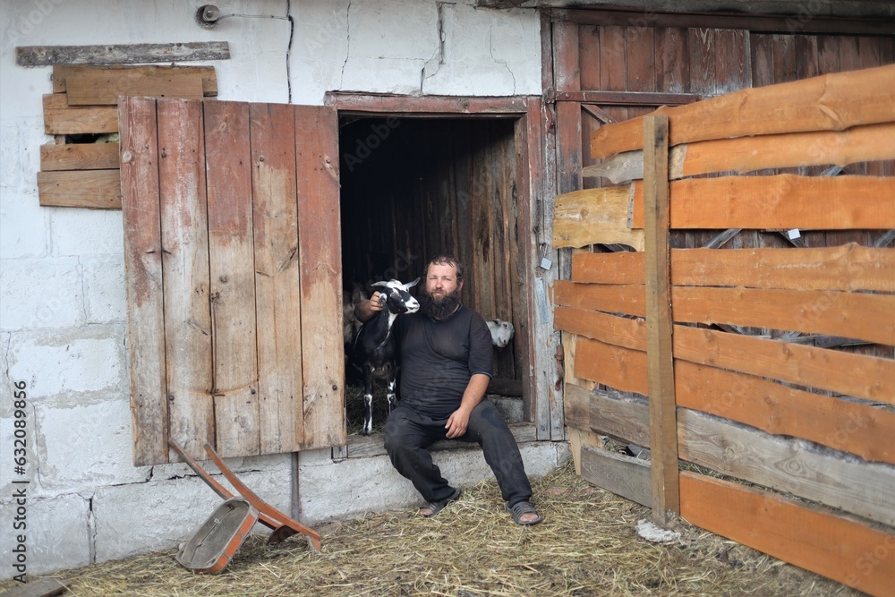 farmer with a beard with an Anglo-Nubian goat farmer with a beard with an Anglo-Nubian goat