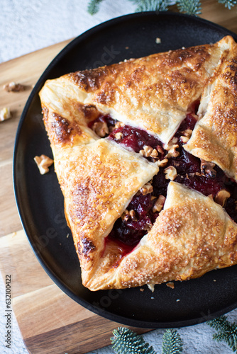 Baked brie cheese and cranberry puff pastry. Homemade puff pastry baking, sweet-savory taste, gourmet appetizer.