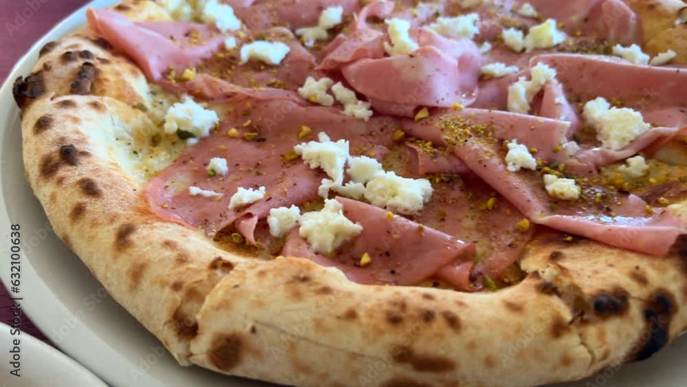 Traditional Italian mortadella pizza with pistachios and burrata