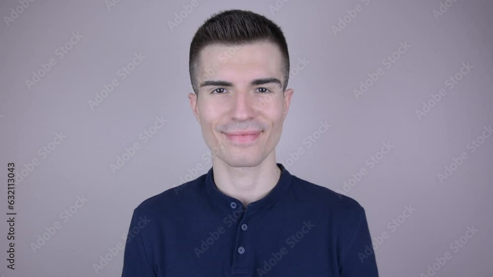Expressive Smiling by Handsome Young Man in Navy Blue T-Shirt - Positive Sign of Contentment and Happiness Expressive Smiling by Handsome Young Man in Navy Blue T-Shirt - Positive Sign of Contentment and Happiness