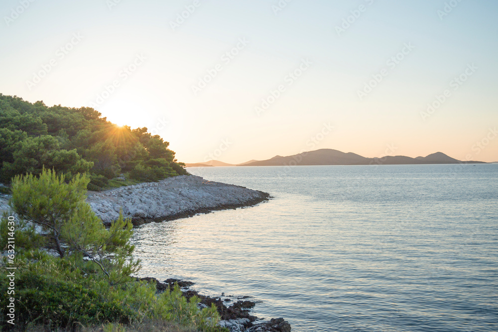 Interesting background, view of the sea, sky and rocky shore on the island of Vrgada at sunset, Dalmatia, Croatia