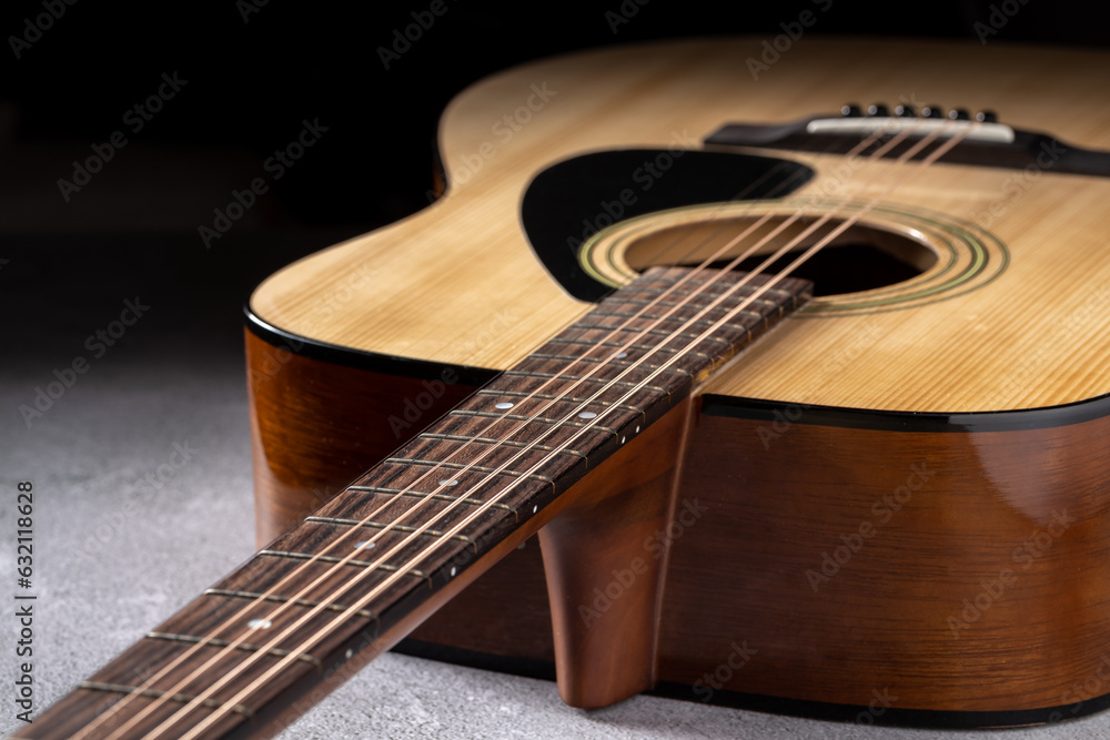Fototapeta premium Classical guitar close up. Acoustic guitar on wood background.Music instrument concept