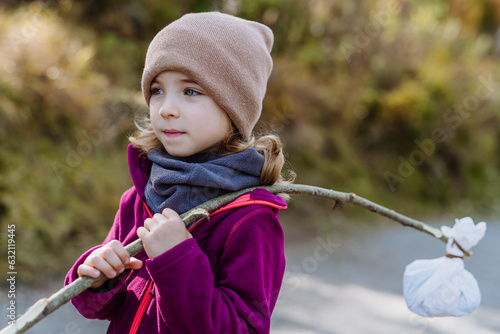 Portrait of little girl with bindle during autumn hike in mountains. photo