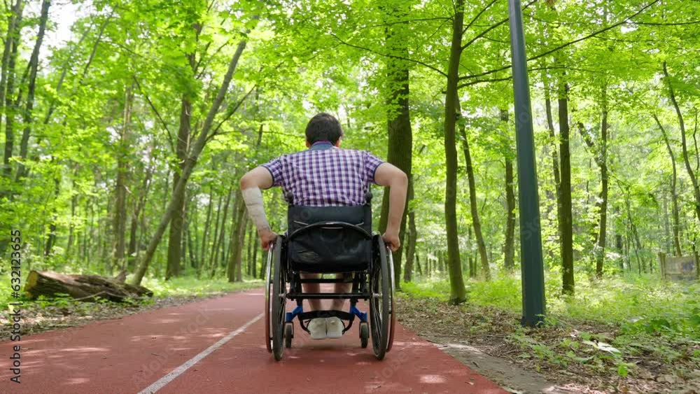A man in a wheelchair rides in the park. A disabled person plays tennis. Disabled person on the sports ground on a sunny day. A man in a wheelchair rides in the park. A disabled person plays tennis. Disabled person on the sports ground on a sunny day.