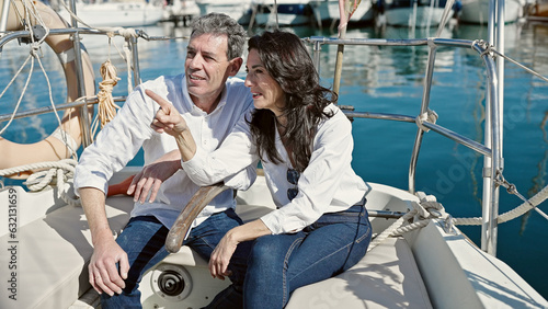 Senior man and woman couple sitting together on boat speaking at boat