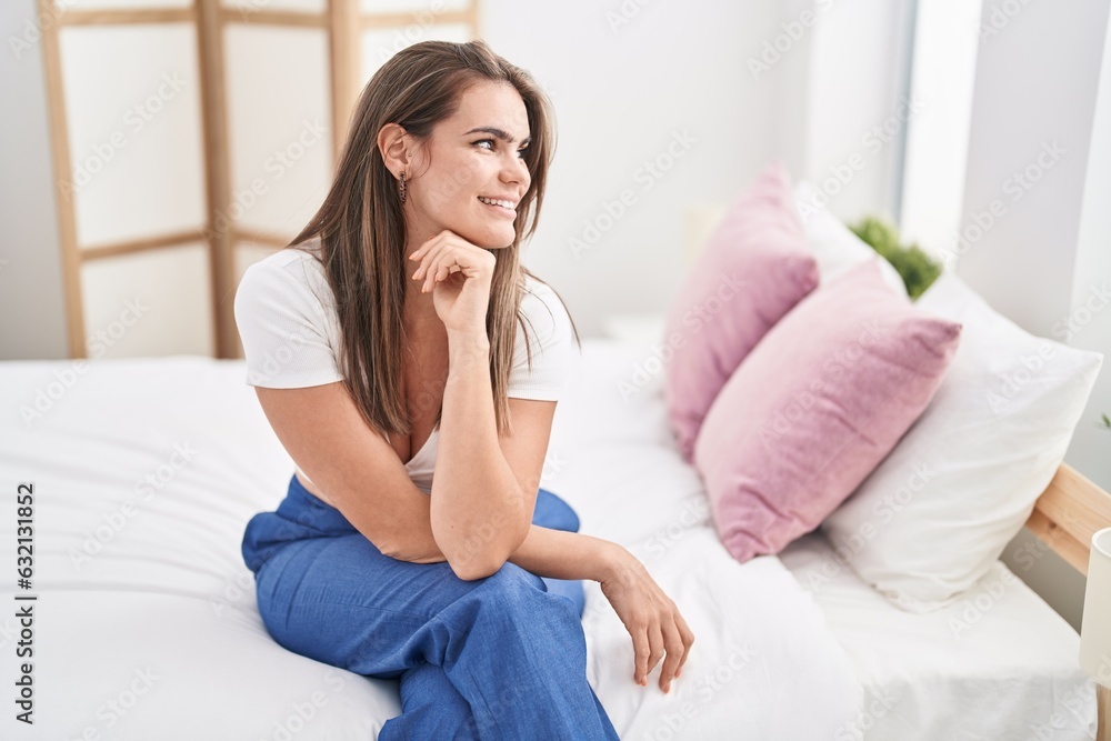 Young woman smiling confident sitting on bed at bedroom Young woman smiling confident sitting on bed at bedroom
