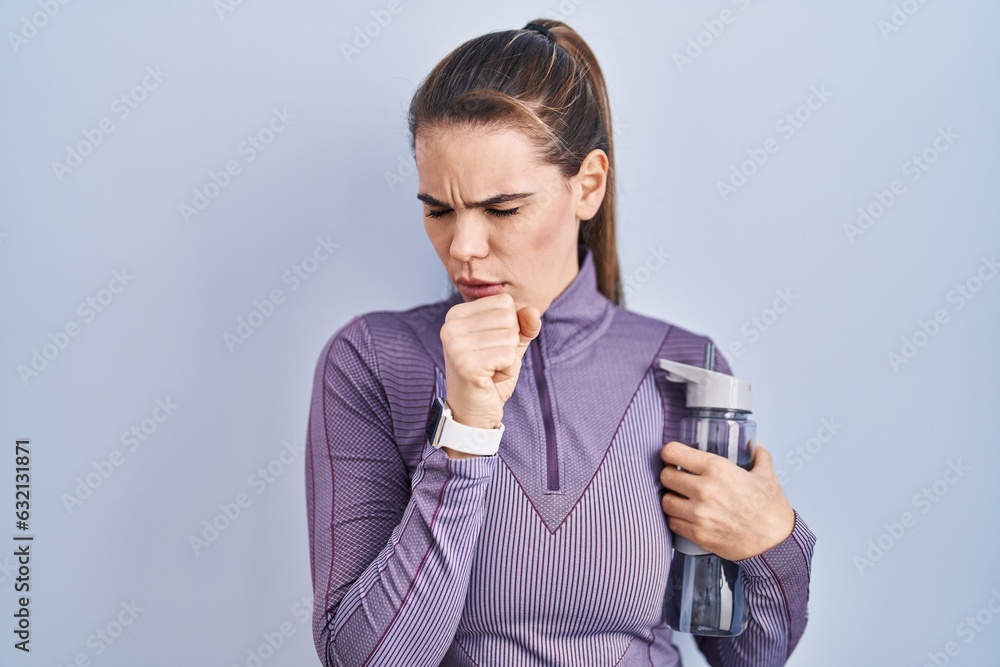 Beautiful woman wearing sportswear holding water bottle feeling unwell and coughing as symptom for cold or bronchitis. health care concept. Beautiful woman wearing sportswear holding water bottle feeling unwell and coughing as symptom for cold or bronchitis. health care concept.