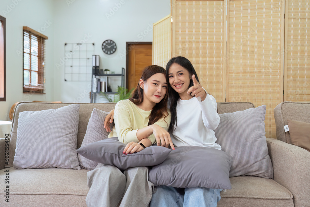 Asian lesbian woman couple enjoy watch TV together in house and feel happy watch movie on television. Homosexual-LGBTQ concept. Asian lesbian woman couple enjoy watch TV together in house and feel happy watch movie on television. Homosexual-LGBTQ concept.