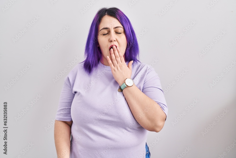 Plus size woman wit purple hair standing over isolated background bored yawning tired covering mouth with hand. restless and sleepiness. Plus size woman wit purple hair standing over isolated background bored yawning tired covering mouth with hand. restless and sleepiness.